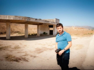 Ben Goldman, video expert extraordinaire at the Jordan Peace Park. In the background are the remains of the abandoned train station part of the power station, which is now the peace park site. Goldman took the outstanding footage featured here (photo credit: Daniel Easterman)